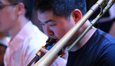 jon hatamiya playing a trombone